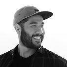 Smiling man wearing a cap, representing customer satisfaction at 369 Markets.